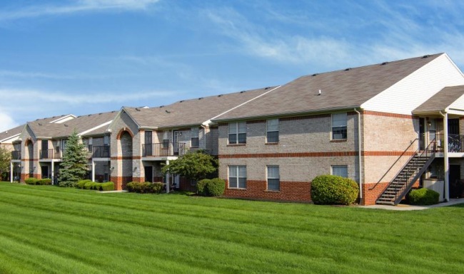 a group of apartments with a lawn