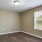 a room with a wood floor and a window with a light