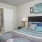 a bedroom with a bed and a lamp