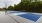 a pickleball court with trees in the background