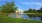 a pond with a building in the background